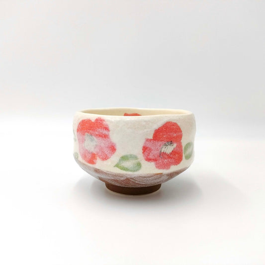 side view of ceramic Tsubaki Macha Mug displaying a pink floral pattern on a white background