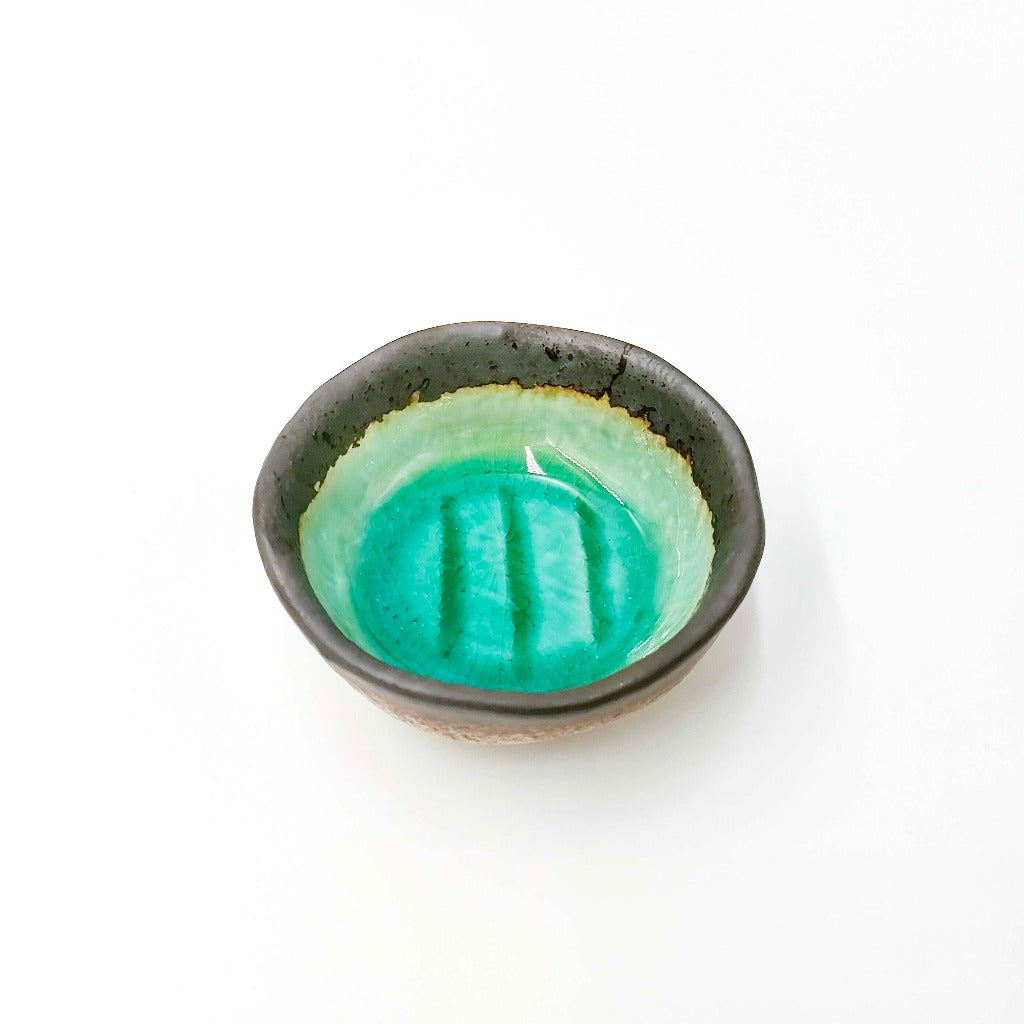 top down angled view of  Maruchiyoku Mamezara with green crackle glaze design on interior surface 