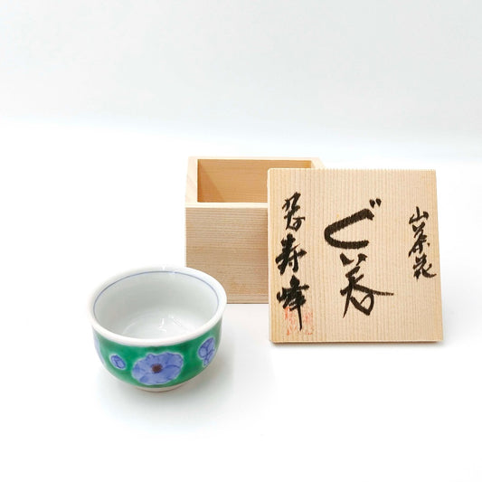 side angled view of Kutani Yaki Sake Cup With Camellia Motif with wooden presentation box