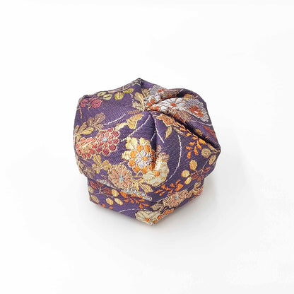 top down angled view of purple floral themed Nuno-Kougou cloth covered traditional Japanese jewelry box with colorful pattern