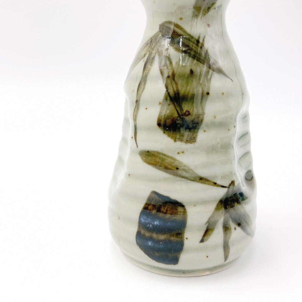 Close up view of side of Mashikotake Sake Set ceramic decanter showing bamboo motifs