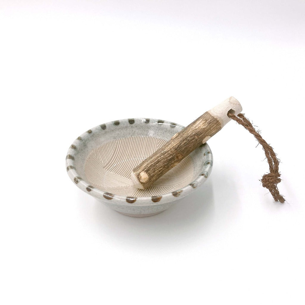 top down angled view of a traditional ceramic Japanese mortar and pestle