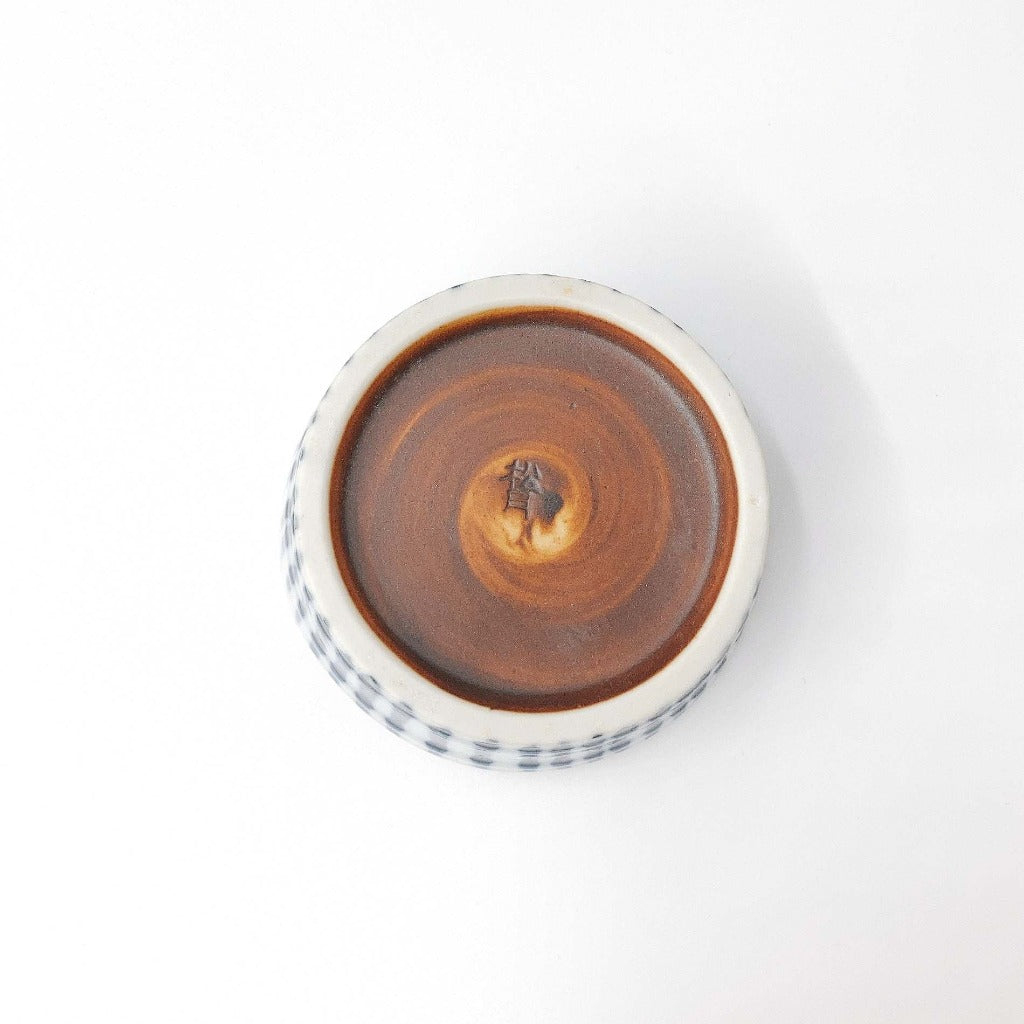 view of base of ceramic blue and white striped Togusa Condiment Holder displaying its brown ceramic base color