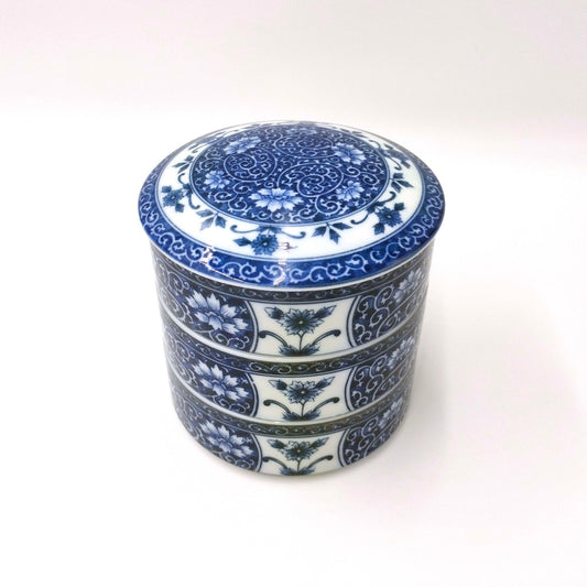 top down angled view of blue ceramic Three Tiered Jūbako displaying intricate floral pattern