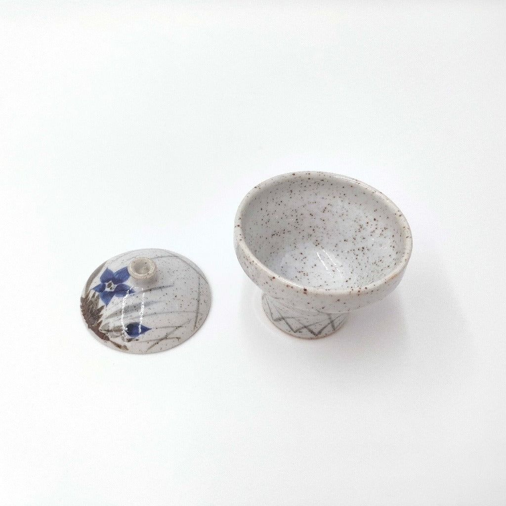 Tp down view of Kikyō Condiment Holder with lid removed and placed to one side showing delicate floral pattern