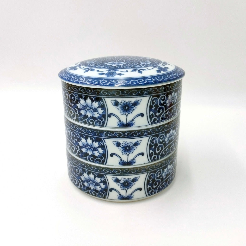 top down shallow angled view of blue ceramic Three Tiered Jūbako displaying intricate floral pattern