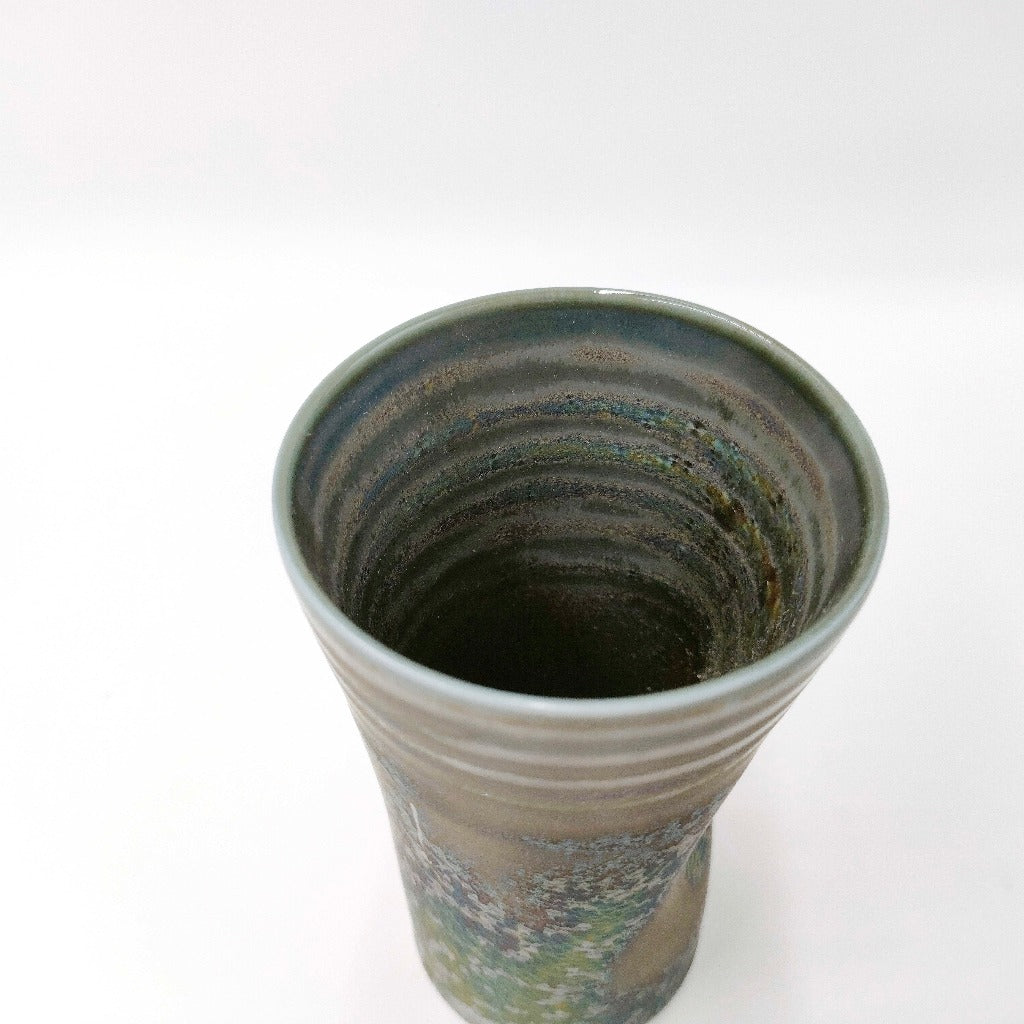 top down angled view of ceramic Tenmoku Cup with oil drop glaze showing its interior