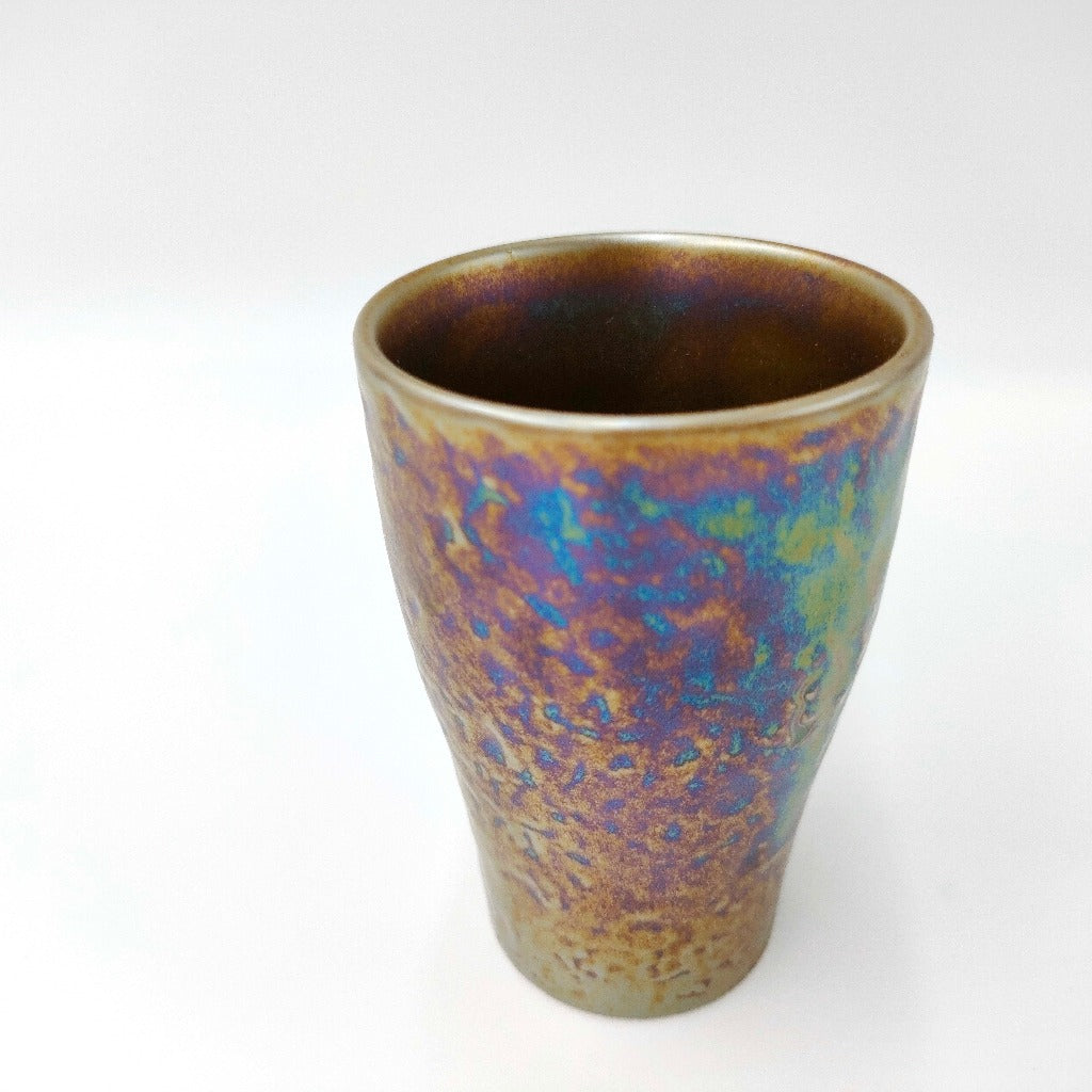 top down angled view of ceramic Tenmoku Cup with oil drop glaze finish