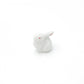 close up side angled view of pink and white ceramic Kyūkyodō Incense Set bunny incense stick holder left side