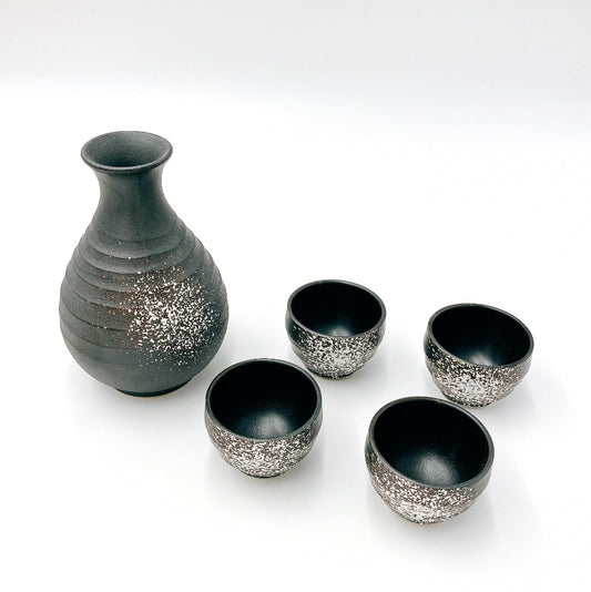 Sabi Shiro Sake Set. View of black sake decanter with white pattern and four matching cups.