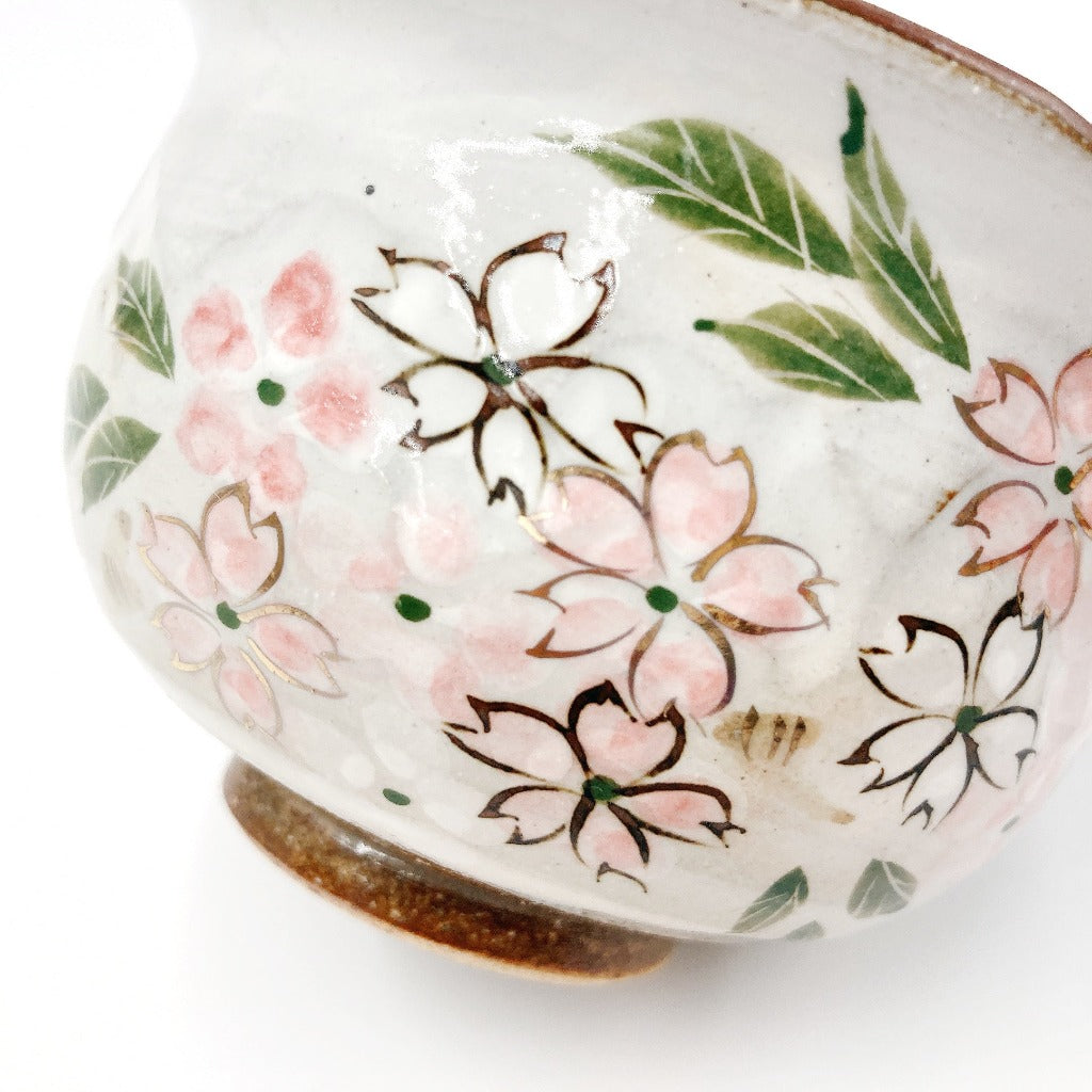 close up view of Shunzan Mori ceramic Hana Kiko Hydrangea Ocha Teacup showing sakura floral pattern