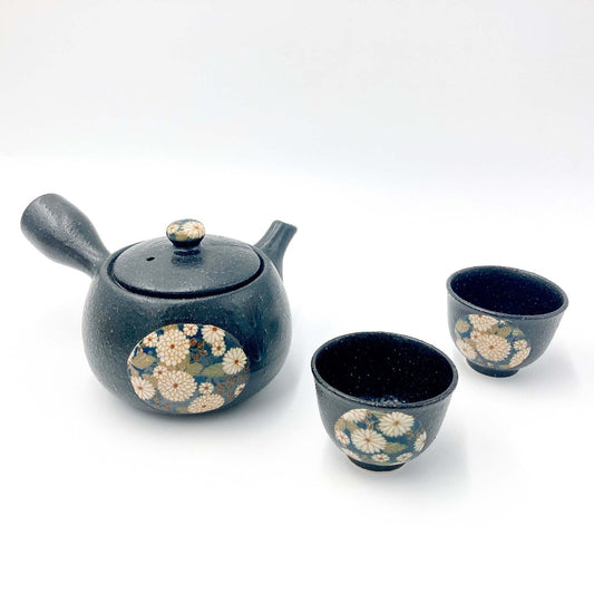 top down angled view of Black Yokode Kyusu teapot with floral motif with two matching cups